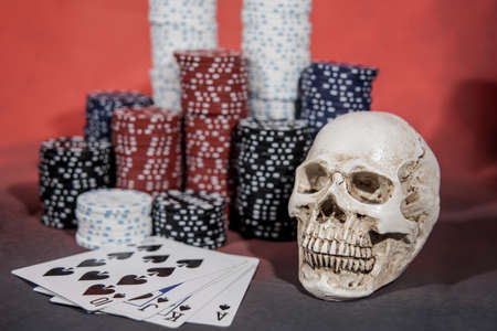 Casino abstract photo. Poker game on red background. Theme of gambling.