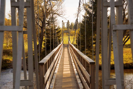 Suspension bridge on a rope on the background of the autumn landscapeの写真素材