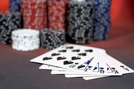 Casino abstract photo. Poker game on red background. Theme of gambling.
