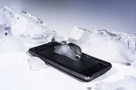 Black smartphone frozen in ice.の写真素材