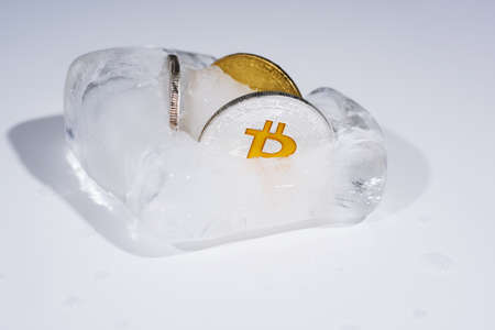 Abstract photo of cryptocurrency. Frozen coins in ice.の写真素材