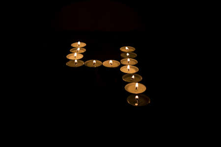 Numbers made from candles on black