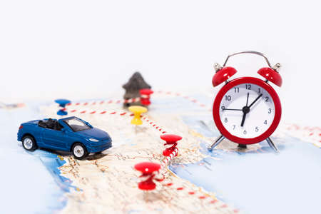 Abstract idea of rent a car. Small car on map. Abstract travel photo.の写真素材