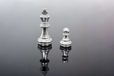 Abstract composition of chess figures. Isolated chess on black mirror.の写真素材