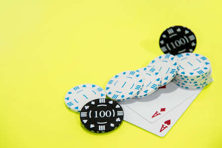 Cards and chips on green and yellow casino table. Abstract casino gambling photo.の写真素材