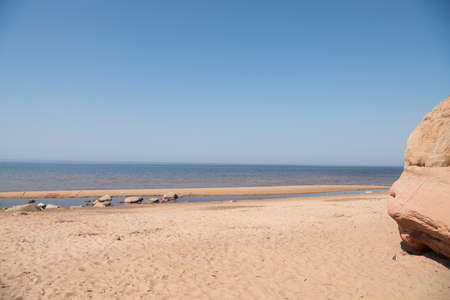 Limestone beach at the Baltic Sea, Latvia with beautiful sand pattern and vivid red and orange color - Veczemju Klintisの写真素材