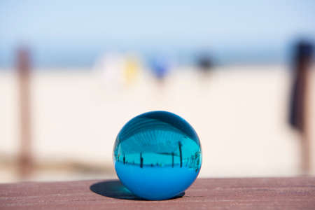 Glass sphere at the beach. Sunny summer day.の写真素材