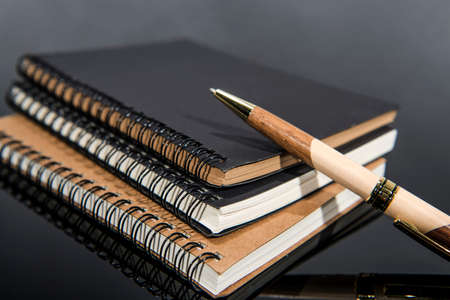 Folders,paper and pen on black glass table.の写真素材