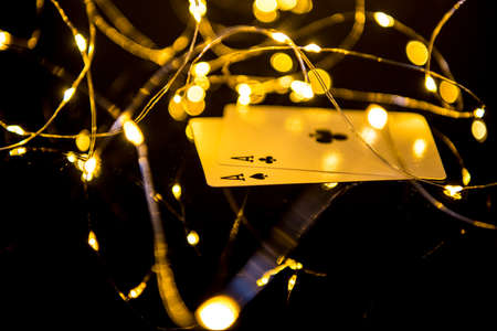 Two black aces cards in blur Christmas lights.の写真素材