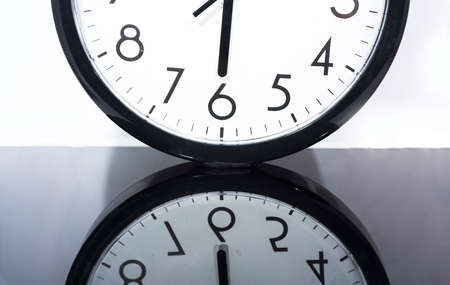 Black old style alarm clock. Isolated on marble background.の写真素材