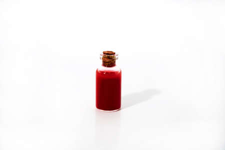 Medicine tube and red drops on white table. Virus abstract photo.