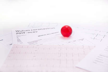 Medicine documents with small red glass balls on it. Abstract photo of illness time.の写真素材