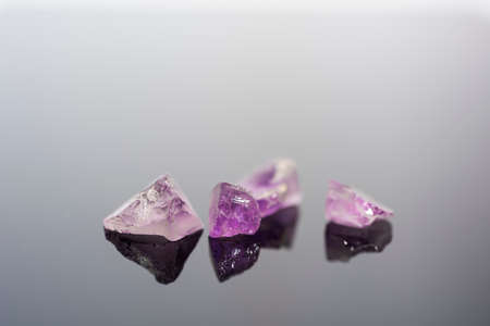 Amethyst small stones. Gems isolated on white background.