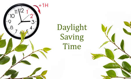 Daylight Saving Time (DST). Blue sky with white clouds and clock. Turn time forward (+1h).の写真素材