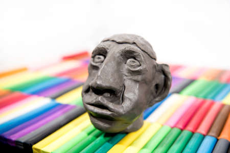 Play clay Animals. Human face on colored background.