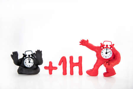 Funny clocks made from Play Clay. Isolated on white background.  Daylight Saving Time concept.