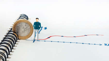 One euro coin over financial graph with small man, economy concept.