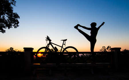 Silhouette of a Beautiful Yoga Woman at Sunsetの写真素材