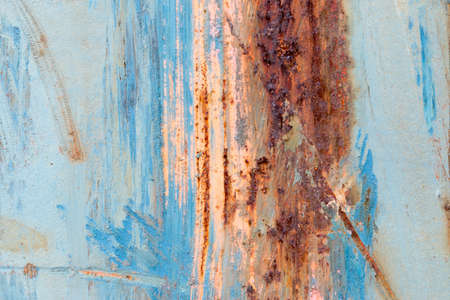 A background of peeling paint and rusty old metal