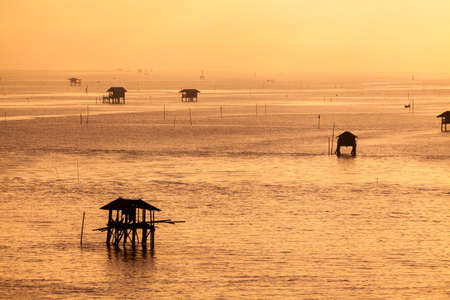 Sunset over the water with cloudy skyの写真素材