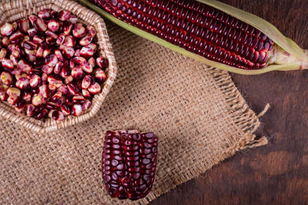 Fresh corn on cobs on rustic wooden table, closeup