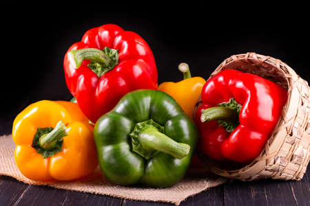 Three sweet peppers on a wooden background, Cooking vegetable saladの写真素材