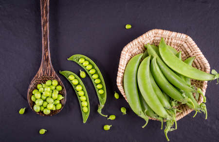 Sugar snap peas with mint on a rustic wood background