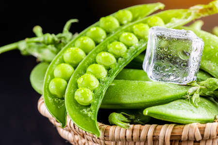 Sugar snap peas with mint on a rustic wood backgroundの写真素材