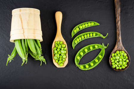 Sugar snap peas with mint on a rustic wood background