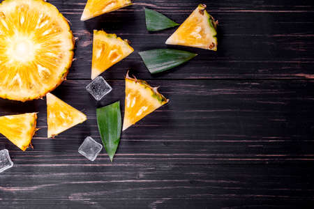 Fresh pineapple on black wood, black background.の写真素材