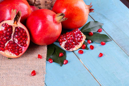 Ripe pomegranate fruits on the wooden background