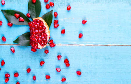 Ripe pomegranate fruits on the wooden backgroundの写真素材