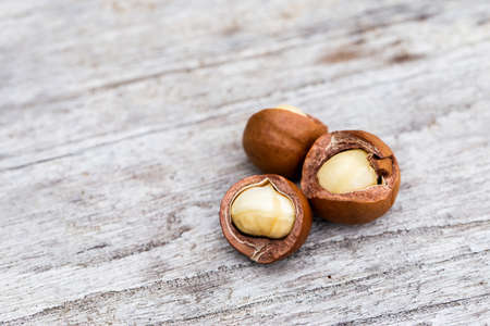 Organic Macadamia nut on wooden tableの写真素材