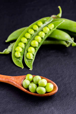 Sugar snap peas with mint on a rustic wood backgroundの写真素材