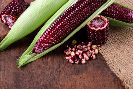 Fresh corn on cobs on rustic wooden table, closeupの写真素材