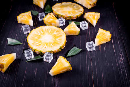 Fresh pineapple on black wood, black background.の写真素材