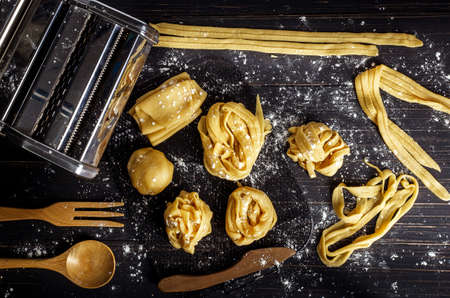 pasta on the wood backgroud ready for cooking. Top view. Copy space