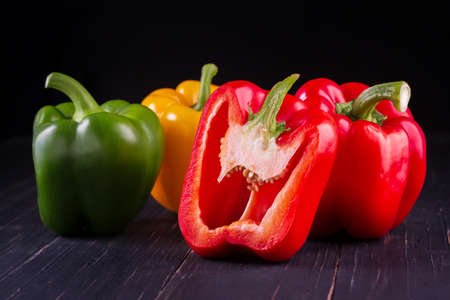 Three sweet peppers on a wooden background, Cooking vegetable salad