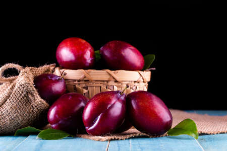 Sweet plums on wooden backgroundの写真素材