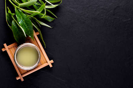 Top view of green tea matcha in a bowl on wooden surfaceの写真素材