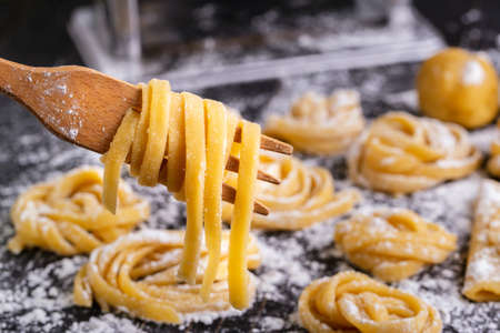 pasta with pasta ingredients on the dark wooden table top view