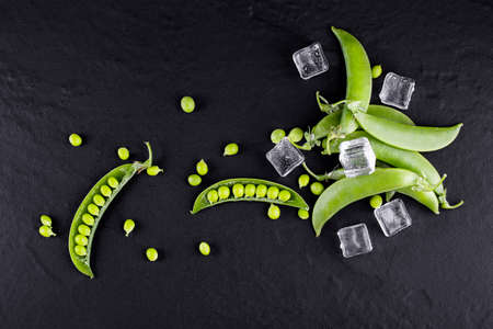 Sugar snap peas with mint on a rustic wood background
