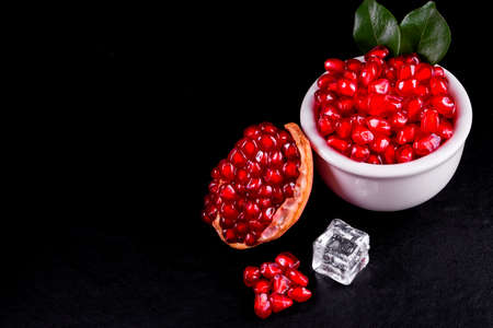 Ripe pomegranate fruits on the wooden backgroundの写真素材