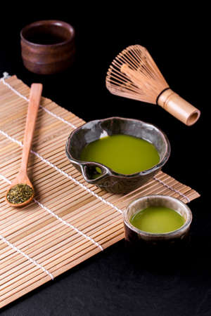 Top view of green tea matcha in a bowl on wooden surface