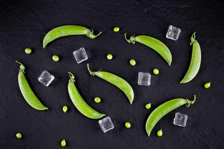 Sugar snap peas with mint on a rustic wood backgroundの写真素材