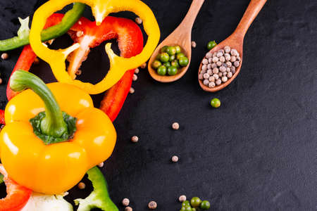 Three sweet peppers on a wooden background, Cooking vegetable saladの写真素材