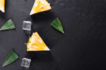 Fresh pineapple on black wood, black backgroundの写真素材