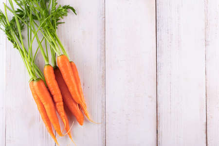 Fresh and sweet carrot on a grey wooden table