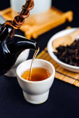Hot tea in glass teapot and cup with steamの写真素材