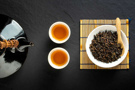 Hot tea in glass teapot and cup with steam